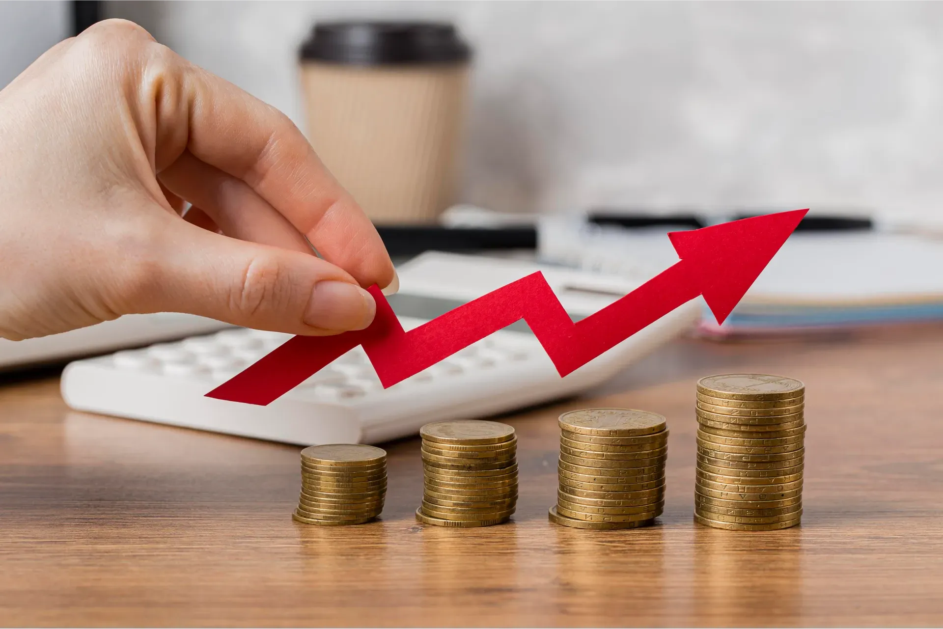 hand_holding_growth_arrow_with_coins.webp