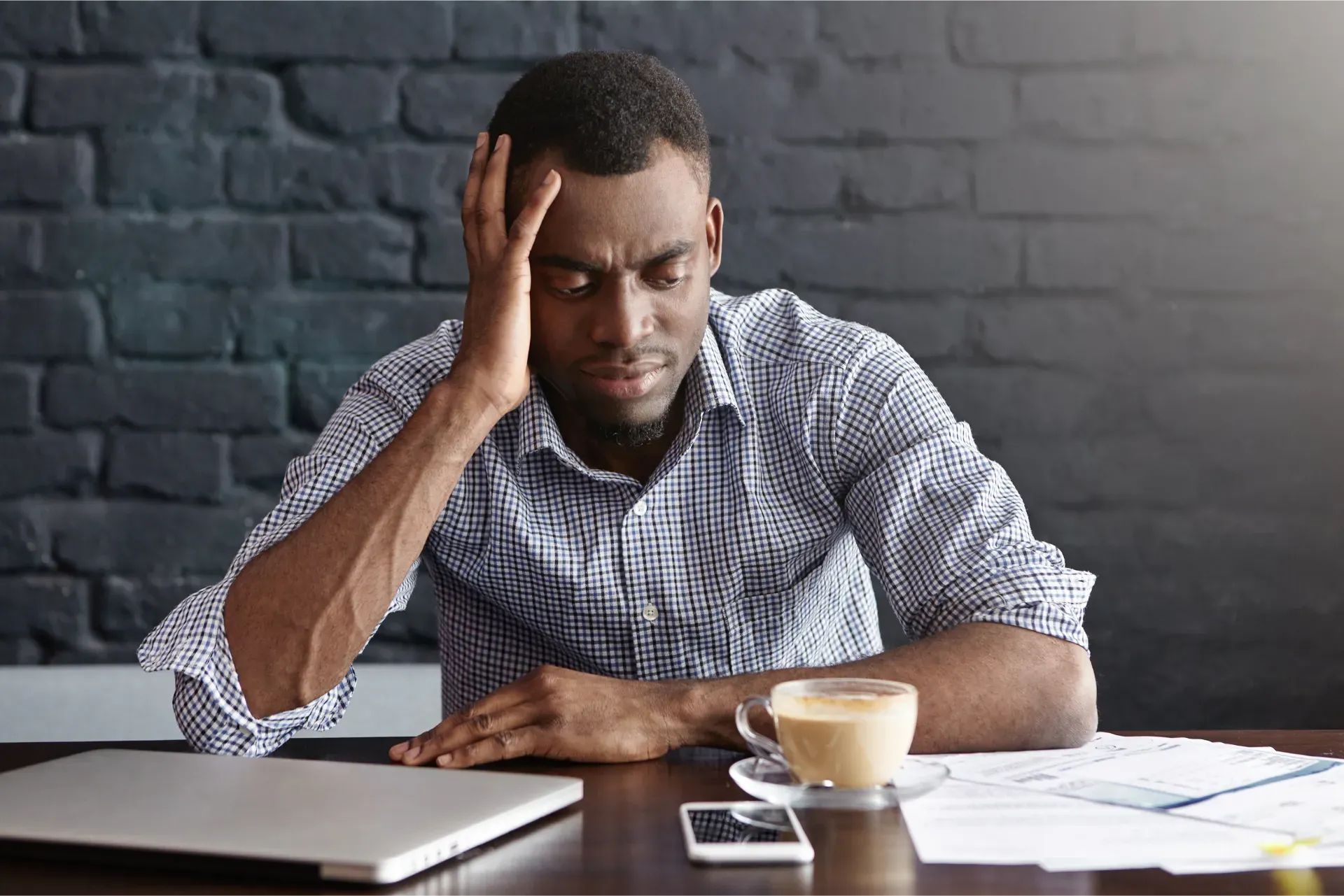 unhappy_african_businessman_feeling_stressed_frustrated.webp